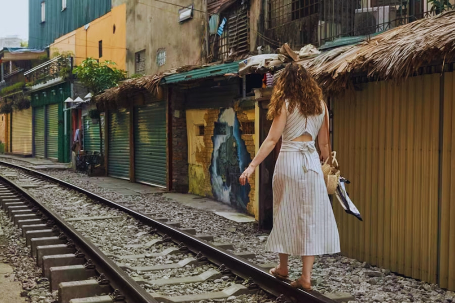 Female solo travel in Vietnam walking along Hanoi train street